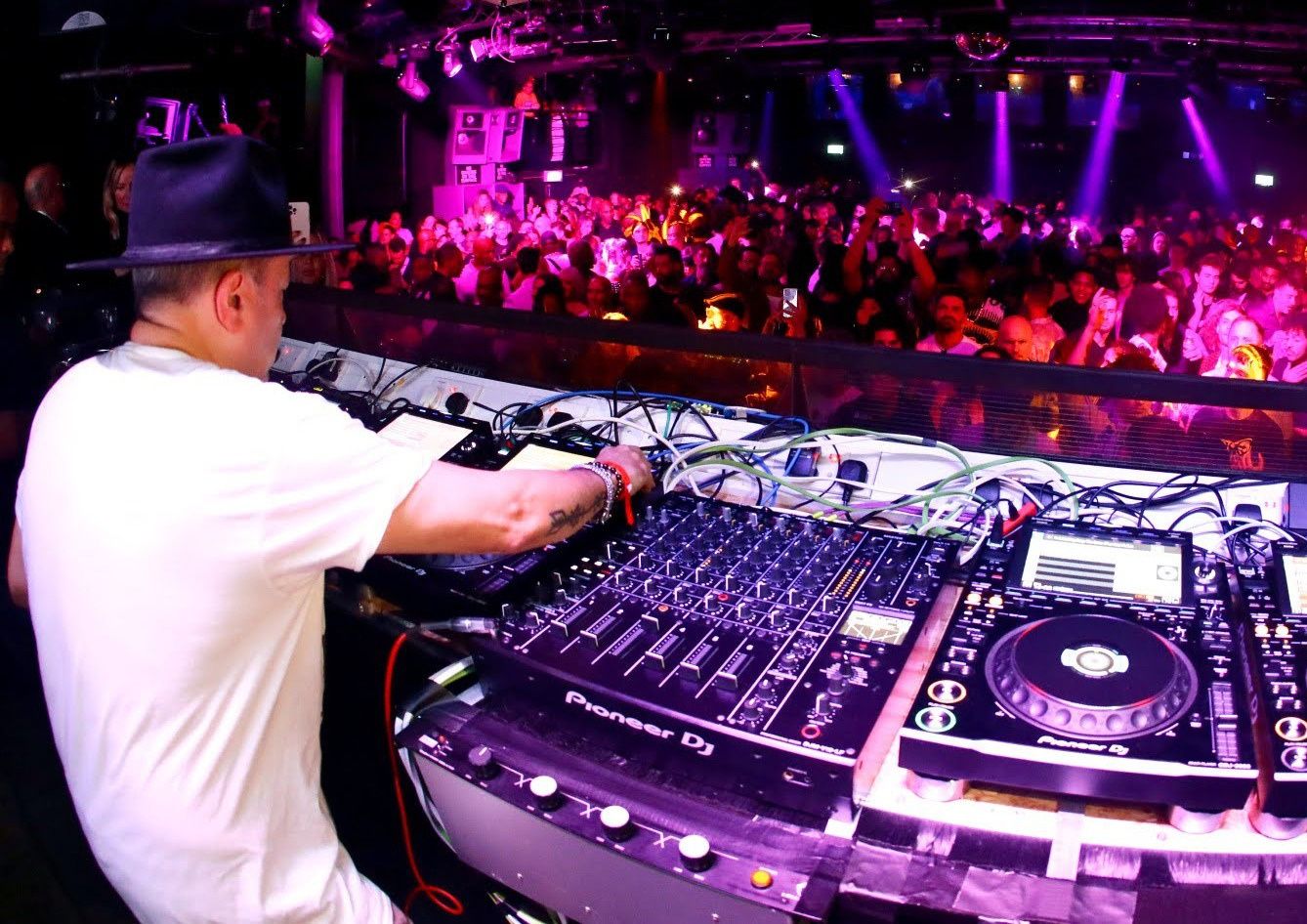 DJ in the booth facing the crowd